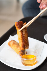 Deep fried Chinese Chives Spring Rolls on a white plate.