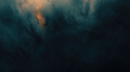 Dramatic dark cloudscape with hints of orange light breaking through.