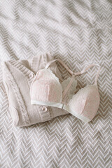 Woman's silk erotic lingerie on the white bed sheets. Valentine's day concept. Lace sexy female underwear. Beauty, fashion blogger concept. Female bra, panties, erotic clothes. Lingerie advertising