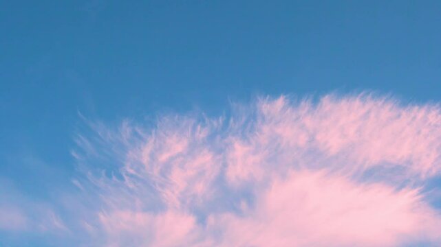 Colorful pure blue sunкшыу sky pink cloud in sunlight time lapse. Beautiful skyscraper colored cloud in sun rays timelapse, dawn sky and clouds background, heaven, aerial view, atmosphere heaven