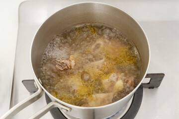 Boiled beef ribs in stainless steel saucepan 
