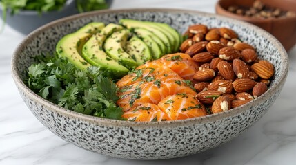 Healthy bowl with avocado, salmon, almonds, and herbs