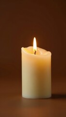 Single white wax candle flame, brown background, reflection, mourning