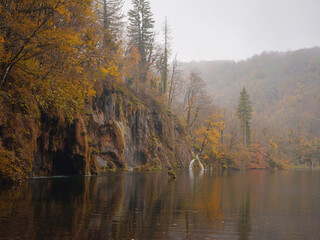 Plitvice Lakes in Croatia during autumn, showcasing stunning waterfalls, vibrant foliage, and crystal-clear waters, creating a magical and serene natural landscape perfect for nature lovers.
