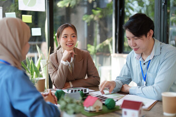 Collaboration for a Greener Future. Professionals engage in dialogue about eco-friendly designs and...