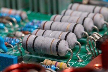 Close-up of resistors and electronics on board electrical circuits.