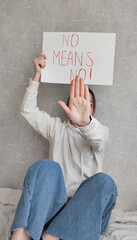 Portrait of a young confident woman holding a banner saying 