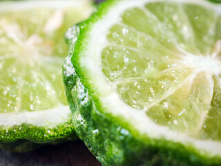 Macro of slices bergamot fruit  on black background, close-up of slices bergamot