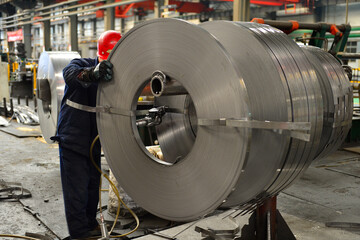 Workers on the production line of the strip steel coil factory are working