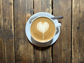 Close Up of an Oat Milk Latte Coffee in White Cup on a Rustic Wooden Table Background with Love Heart
