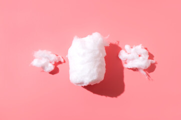 Delicate fluffy pieces of cotton wool on light background, top view. Cotton clouds, natural eco-friendly material for hygiene, medicine, health, fabric manufacturing