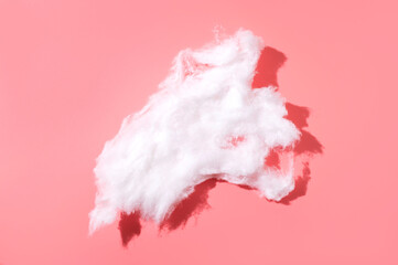 Delicate fluffy pieces of cotton wool on light background, top view. Cotton clouds, natural eco-friendly material for hygiene, medicine, health, fabric manufacturing
