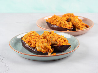 Baked eggplants stuffed with corn couscous with chickpea sauce
