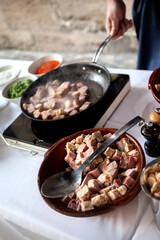 The caterer is cooking on the buffet