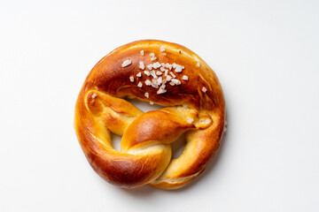 Pretzel with coarse salt on a white background.