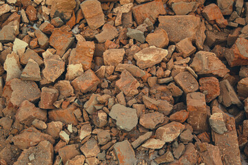 background from an old broken brick. stones for construction