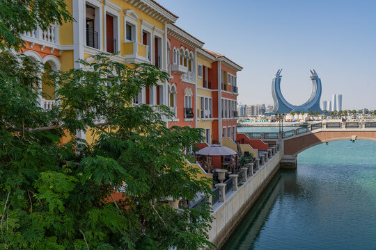 View of colorful buildings and a canal with a bridge in a vibrant skyline, Al Souq, Doha, Qatar.