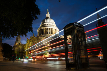 London, United Kingdom - 23 September 2022: View of illuminated historic cathedral and vibrant city lights with light trails, Central London, England, United Kingdom.