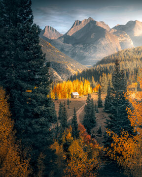 View of tranquil autumn forest with rustic cabin and vibrant fall colors, Silverton, Colorado, United States.