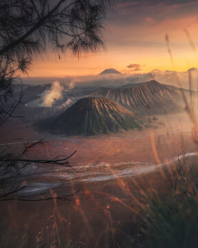 View of majestic Mt. Bromo volcano at sunrise with dramatic smoke and mist, Sukapura, Probolinggo, East Java, Indonesia.
