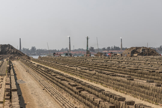 View of industrial brick fields with factories and chimneys emitting smoke, Dhaka, Dhaka Province, Bangladesh.