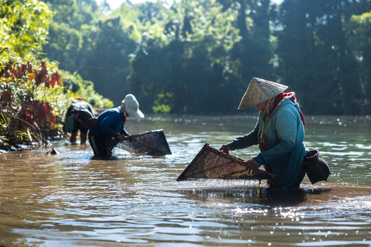 View of Laos people fishing for shrimp in the local river near Kong Lor cave, Laos, Southeast Asia