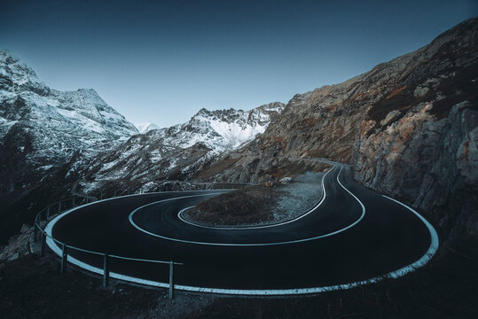 View of winding mountain road with scenic curves and majestic peaks, Wassen, Uri, Switzerland.