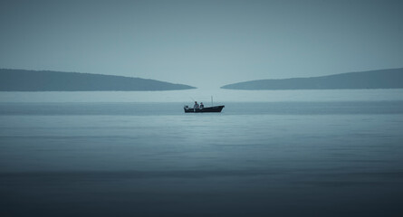 Brištane, Croatia - 19 April 2022: View of a serene sailboat on calm waters with a beautiful coastline and sparkling sea, Bristane, Croatia.