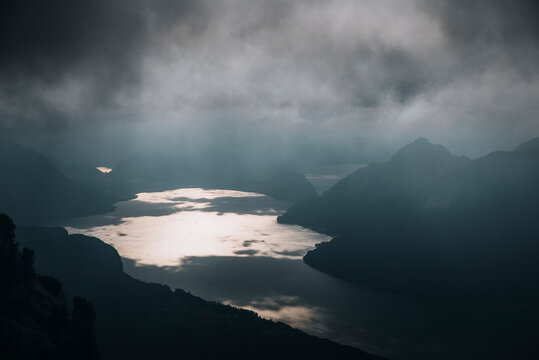 View of serene lake surrounded by majestic mountains and cloudy sky, Stoos, Schwyz, Switzerland.