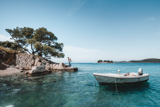 Grebaštica, Croatia - 22 April 2022: View of tranquil Grebastica coastline with clear blue sea and picturesque boats, Grebastica, Sibenik-Knin County, Croatia.