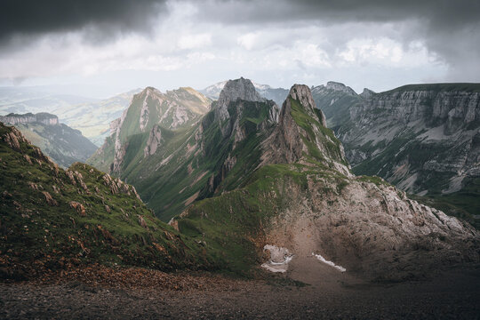 View of majestic snow-capped mountain peak and serene valley under a cloudy sky, Brulisau, Appenzell, Switzerland. - Powered by Adobe