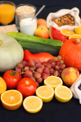 Various healthy fruits, vegetables and cereals on dark background. Selective focus.