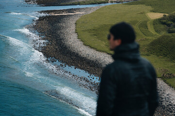 View of serene coastal landscape with rocky shore and tranquil ocean, Lairg, Scotland, UK.