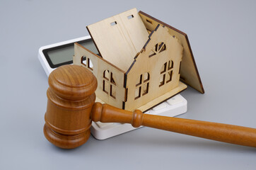 Real estate, house insurance and court verdict concept. Damaged house with wooden gavel and...