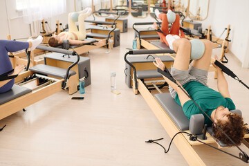 Dynamic pilates session in a bright and spacious studio featuring various exercises