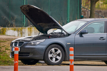 a car with the hood up for inspection