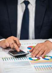 Businessman Analyzing Financial Charts and Stock Market Data