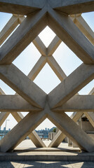 Fototapeta premium Sunlit concrete arches creating an interplay of light and structure.