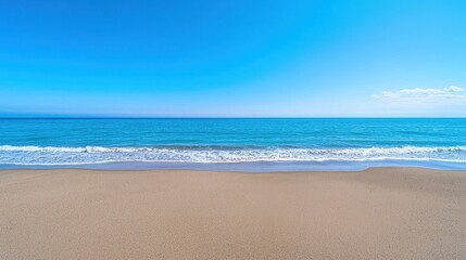 Clear turquoise ocean waves gently lap against sandy beach