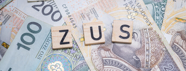 The word "ZUS" (Polish Social Insurance Institution) on a background of Polish banknotes, symbolizing social security, public funds, and financial obligations in Poland