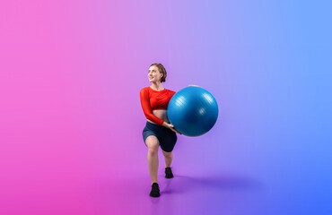 Full body length gaiety shot athletic and sporty young woman with fitness exercising ball in...
