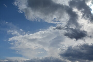 The sun breaks through the clouds against a blue sky