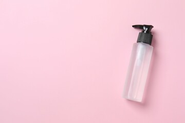 Natural cosmetic products. Cosmetic bottle on a pink background, top view
