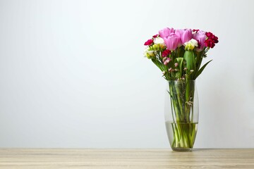 Beautiful bouquet of fresh flowers in a vase on the table