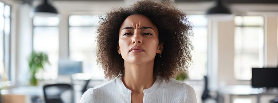 Serious woman in office, focused expression