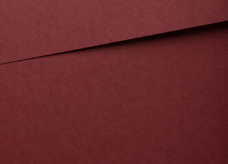 Fototapeta premium Deep burgundy paper background with a matte, grainy texture and subtle fibrous surface. Elegant red tones and minimalistic design create a luxurious, premium finish, ideal for designer paper and.