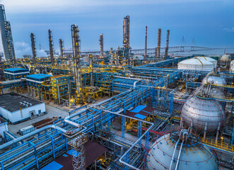 Complex industrial plant and oil refinery at dusk