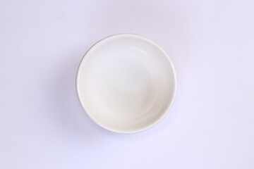 Isolated white bowl in the white background placed in the center from the top angle view
