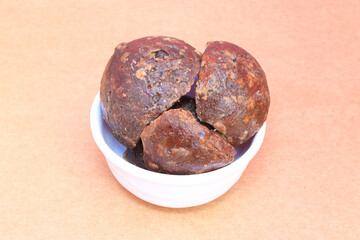 South indian, Tamil nadu famous palm jaggery pieces in the white bowl placed in the brown background