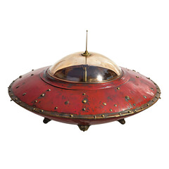 retro-futuristic ilustration of a red metal flying saucer with a glass bubble cockpit